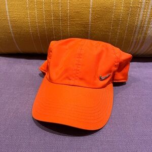 Nike Heritage86 Metal Swoosh cap in a bright orange or "kumquat" color